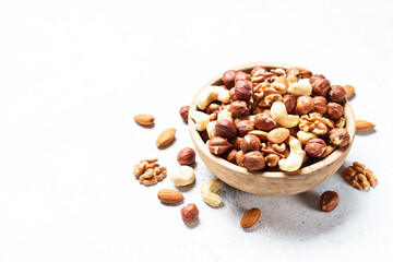 Nuts assortment at white background. Almond, hazelnut, cashew in wooden bowl. - 790809957