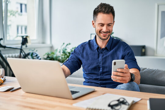 Smiling adult man working from home office