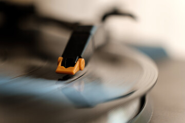 Macro view of head-shell turntable playing a record.
