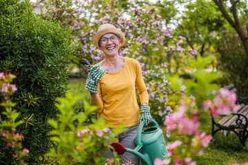 Portrait of happy senior woman gardening. - 790822123