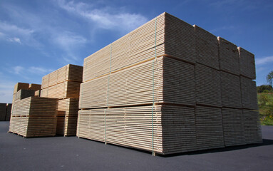 Stacks of timber planks on a sawmill storage area in Germany