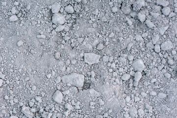 Background, texture of a heap of gray gravel, granite, crushed stone from small pebbles. Photo, top...