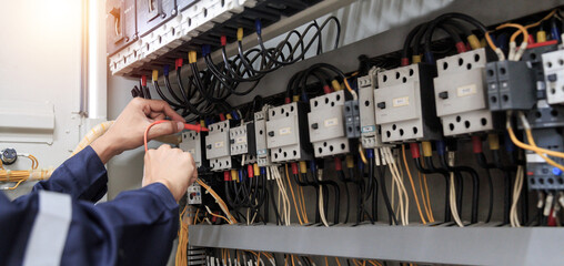Electricity and electrical maintenance service, Engineer hand holding AC voltmeter checking...