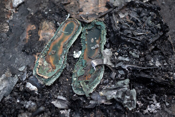 old burnt shoes in ashes