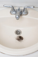 Blockage  of bathroom sink with woman hair