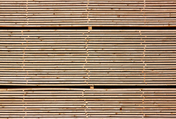 Abstract texture of stacked timber boards in a sawmill storage area in Germany ready for shipping