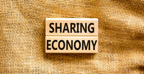 Sharing economy symbol. Concept words Sharing economy on beautiful wooden blocks. Beautiful canvas...