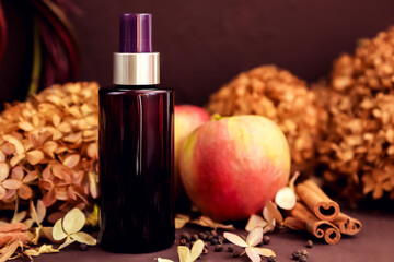 cosmetic oil spray bottle, apples, cinnamon, dried flower. Skincare beauty and liquid antibacterial...