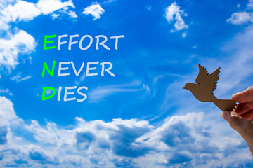 END effort never dies symbol. Concept words END effort never dies on beautiful blue sky clouds...