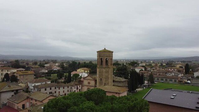 Drone shot of the Parish Church of San Nicolo and the bell tower in San Niccolo di Celle, Italy