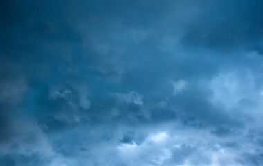 Storm clouds, moody weather in the dark blue sky background. Storm season.
