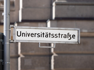 Universit&auml;tsstra&szlig;e (university street) sign in Berlin. Road name guide at an intersection. The location is in the Mitte district and the famous Humboldt University is there.