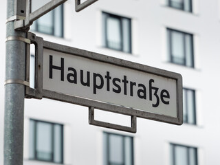 Hauptstraße (main street) sign in Berlin, Germany. Road name guide at an intersection in the city....