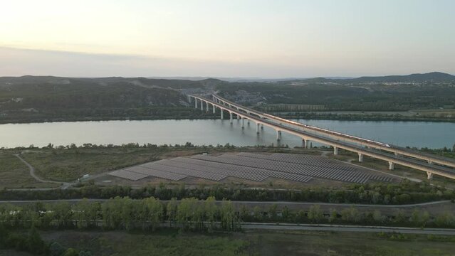 Panoramic aerial view of a high-speed passenger train passing on a double viaduct over the Rhone River in Avignon - France.
