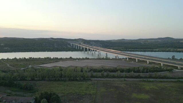 Panoramic aerial view of a high-speed passenger train passing on a double viaduct over the Rhone River in Avignon - France.