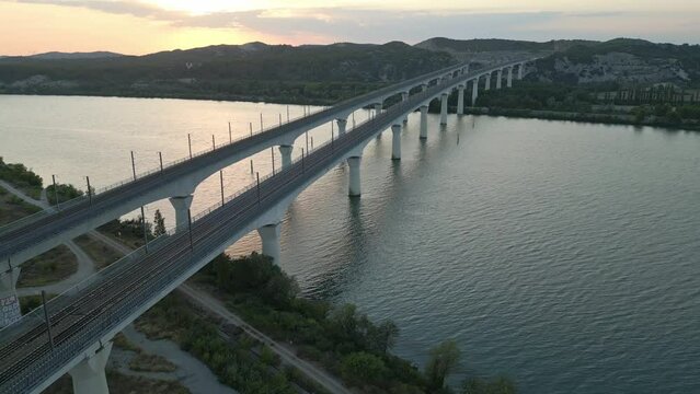 Panoramic aerial view of the double viaduct for high-speed passenger trains over the Rhone river in Avignon during sunset - France
