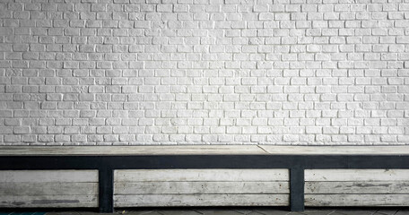 white brick wall background with mockup metal table, Minimal workplace against brick wall. Copy...