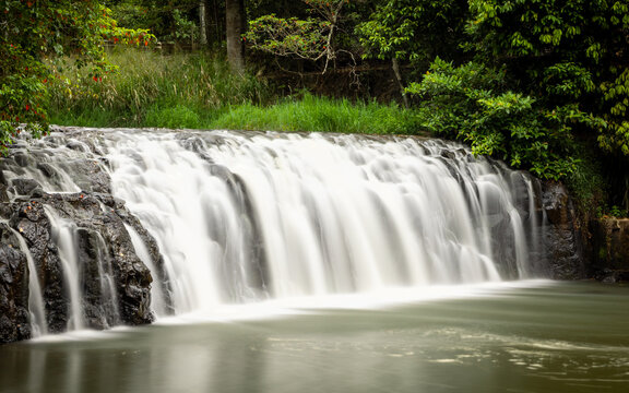 Malanda falls waterfall flowing into the town recreational swimming hole in the town of Malanda on the North Johnstone River on the Atherton Tableland in tropical Queensland, Australia,