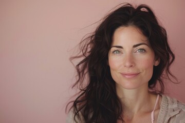 Fototapeta premium Studio Portrait of Smiling Woman with Light Pink Background
