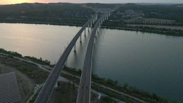 Panoramic aerial view of the double viaduct for high-speed passenger trains over the Rhône river in Avignon during sunset - France