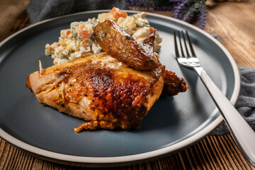 Roast chicken served with russian traditional salad.
