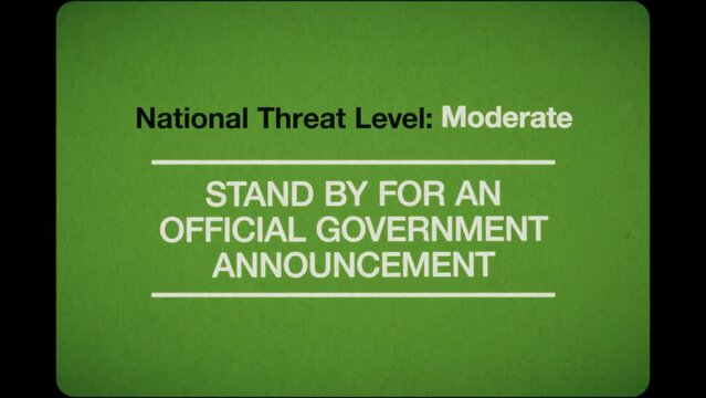 A TV caption card in a retro 1970s 16mm film style with the wording ‘National Threat Level: Stand by for an official government announcement’. The graphics are created in an analogue cardboard and tra