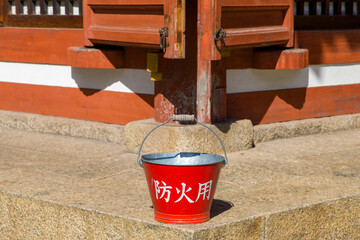 a red bucket with the japanese inscription 