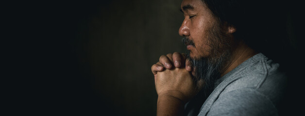 Person man, turned to God in prayer, demonstrating their religious faith and devotion through...