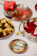 Traditional puja thali - plate for the ritual ceremony with kumkum, haldi or turmeric powder, flowers and diya (oil lamp). Hindu sacral element for worshipping God.