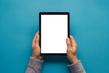 Photo Hand holding tablet with blank screen on blue background