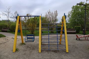 Outdoor playground for kids. Swing equipment for children outdoor.