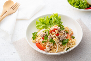 instant noodle spicy salad.Thai hot and sour noodle salad with minced pork that is very flavorful and addictive