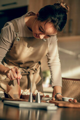 moment of concentration in a kitchen, showcasing the step-by-step process involved in creating perfectly decorated cupcakes