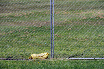 Construction site fence and yellow sandbag