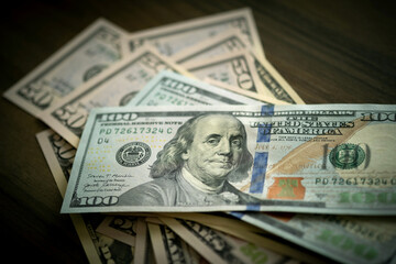 A thoughtful arrangement of $50 and $100 bills graces the desktop, highlighting wealth's textures - 790880398
