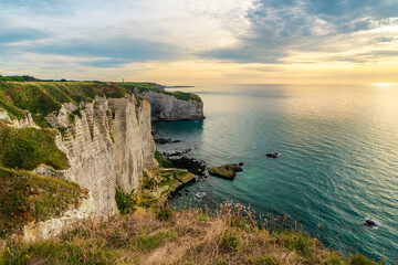 White chalk natural cliffs Aval of Etretat, Normandy, France. French sea coast in Normandie with famous rock formations at sunset. Travel destination - 790880966