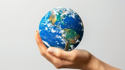 Human hand gently cradling the Earth, symbolizing care and stewardship for our planet
