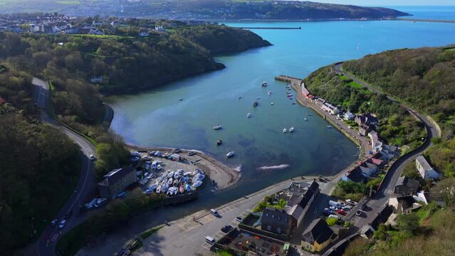 Aerial shot of small fishing village harbour with boats at Fishguard, Pembrokeshire, Wales.