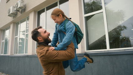 Daughter run to father hug lift pick up happy family meeting child offspring little girl schoolgirl elementary school kid educational study support parenthood relations enjoying embrace cuddle care