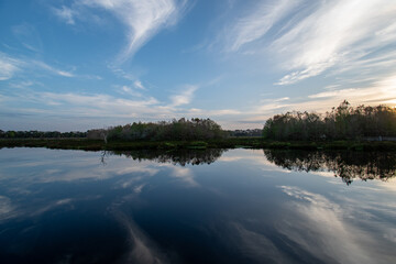 Boardwalk and sunrise cloudscape over constructed wetlands of Green Cay Nature Center in Boynton Beach, Florida..