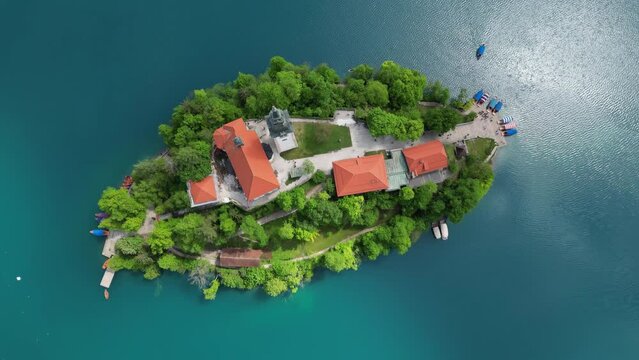 Aerial top view Pilgrimage Church of the Assumption of Maria on a small island, Bled lake, Slovenia, 4k