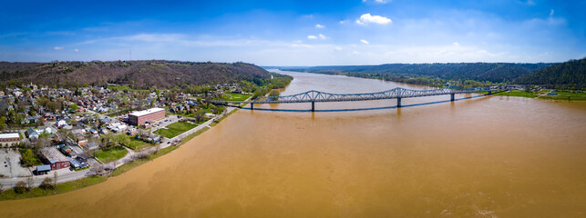 Aerial panorama of the bridge linking Madison, Indiana and Milton, Kentucky over brown waters of Ohio river