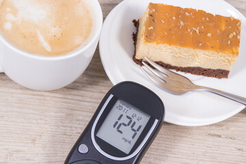 Glucose meter with high result sugar level, portion of sweet cheesecake and cup of coffee with milk. Nutrition during diabetes