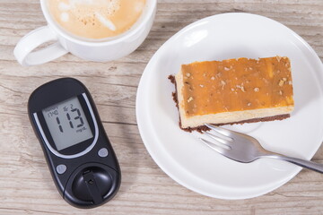 Glucometer, portion of cheesecake and cup of coffee with milk. Measuring and checking sugar level during diabetes