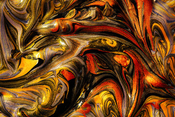 Closeup of gold, red and black fluid metallic paint textured background
