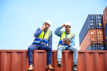 container operators wearing helmets and safety, vests control via walkie-talkie workers in container yards. Cargo Ship Import Export Factory Logistic.