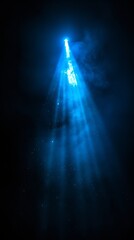 a blue light source floating through pitch black space