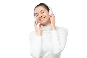 Young woman relaxing to sounds of music she is listening in wireless headphones with smile