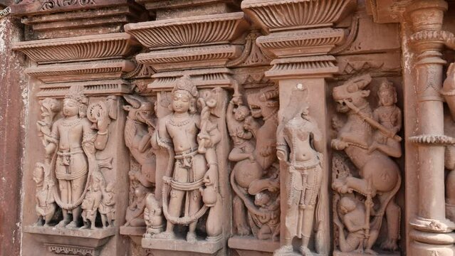 ancient hindu temple artistic wall decorated with god and goddess idols at day from different angle