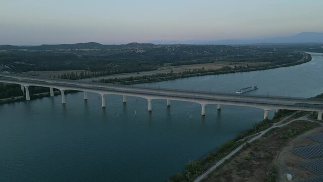 Panoramic bird's eye view of a passenger ship passing under the double viaduct on the Rhone River in Avignon - France.